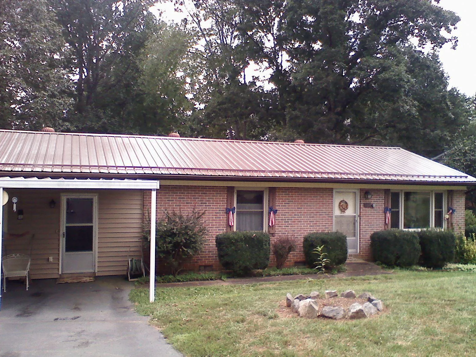Bronze metal roof and carport on a brick ranch home — Roof Repair work by our crew in Louisa